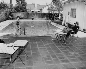 Photograph caption dated September 30, 1961 reads, "Typical of the relaxed outdoor living in the San Fernando Valley is this scene around the backyard swimming pool. Children enjoy the fun under watchful eye of grownups. Thousands of these relaxation spots dot the Valley and more are being built each year." order# 00082908